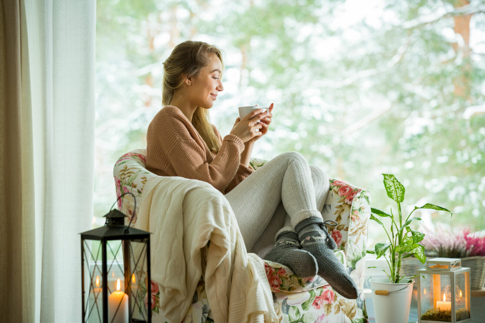 Boost your cozy nest by adding soft lighting, warm textures (like throws and rugs), and personal touches that make you feel at ease.